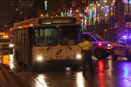Winnipeg Police and Transit officials are on scene at Carlton and Portage Ave investigating a bus/ pedestrian accident and a Winnipeg Transit bus  Westbound lanes of Portage Ave are blocked as the investigation continues- Breaking News  Dec 12, 2014   (JOE BRYKSA / WINNIPEG FREE PRESS)