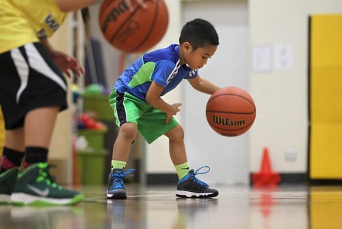 49.8 feature on the Philippine Basketball League of Winnipeg.  Lenin Mangaron, former college star now coaches young team at Sargent Park School.   Five year old Kandon Mangaron practices with team.   Dec 13/14 Ruth Bonneville / Winnipeg Free Press