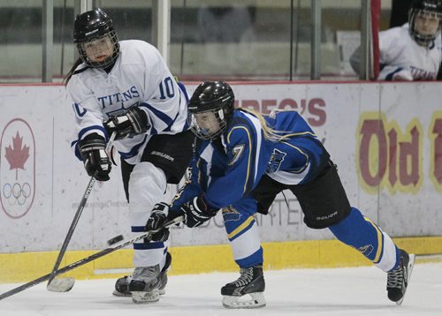 December 14, 2014 - 141214  -  Wesman Wildcats' Paige Hubbard (7) attempts to steal the puck from Bantam AA Titans' Jadyn Friesen (10) at Hockey Manitoba's Project 100 Sunday, December 14, 2014. The weekend was a celebration of women's hockey in Manitoba. John Woods / Winnipeg Free Press