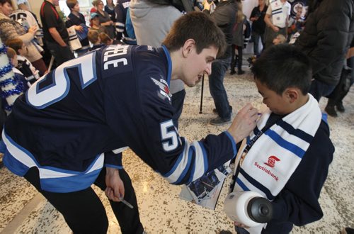 Bernard Rosello  gets a autograph fromWinnipeg Jets player Mark Scheifele at The Rehabilitation Centre for Children Monday afternoon- Members of the team also visited the Childrens Hospital, and the Psychiatric Unit at Health Sciences Centre. - Standup photo  Dec 15, 2014   (JOE BRYKSA / WINNIPEG FREE PRESS)