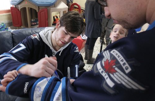 Joseph Schollenberg gets a autograph from Winnipeg Jets player Adam Lowry at The Rehabilitation Centre for Children Monday afternoon- Members of the team also visited the Childrens Hospital, and the Psychiatric Unit at Health Sciences Centre. - Standup photo  Dec 15, 2014   (JOE BRYKSA / WINNIPEG FREE PRESS)
