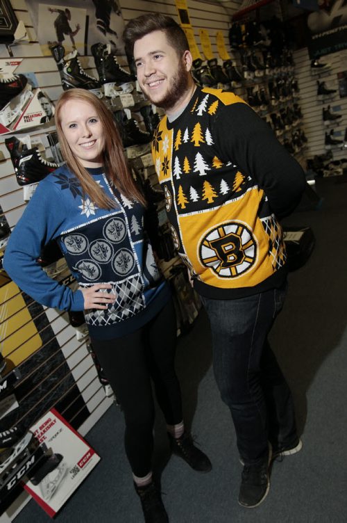 December 15, 2014 - 141215  -  On Monday, December 15, 2014 Royal Sports sales associates Naomi Sawchuck and Alex Guidry wear the hockey sweaters that have been hot this Christmas.  John Woods / Winnipeg Free Press