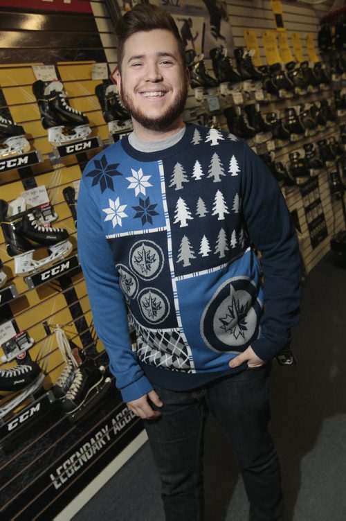 December 15, 2014 - 141215  -  On Monday, December 15, 2014 Royal Sports sales associates Naomi Sawchuck and Alex Guidry wear the hockey sweaters that have been hot this Christmas.  John Woods / Winnipeg Free Press
