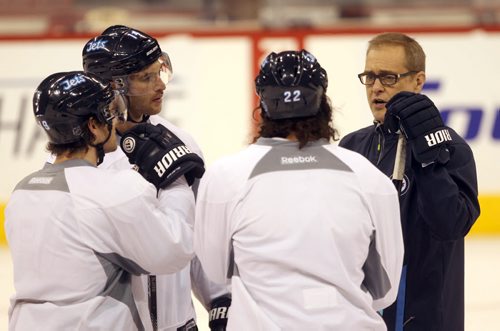Winnipeg Jets head coach Paul Maurice has a chat with players L to R  Jim Slater, Anthony Peluso, and Chris Thorburn at morning practice Tuesday.- The Jets are in preparation for a home game tonight against the Buffalo Sabers- See Ed Tait story  Dec 16, 2014   (JOE BRYKSA / WINNIPEG FREE PRESS)