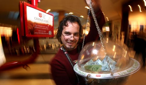 David Giasson, who volunteers to man the Salvation Army Kettle at Polo Park shows of the proceeds part way through his shift Tuesday. See story re: Manitoba's generosity. December 16, 2014 - (Phil Hossack / Winnipeg Free Press)