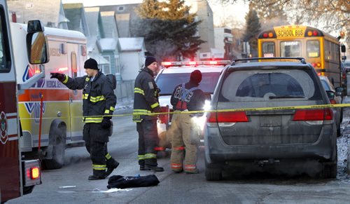 Emergency crews on Selkirk Ave. at Parr St. after a woman was struck by a school bus Wednesday morning. Wayne Glowacki / Winnipeg Free Press Dec.17 2014
