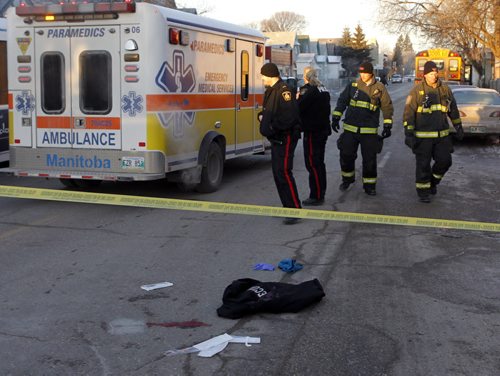 Emergency crews on Selkirk Ave. at Parr St. after a woman was struck by a school bus Wednesday morning. Wayne Glowacki / Winnipeg Free Press Dec.17 2014