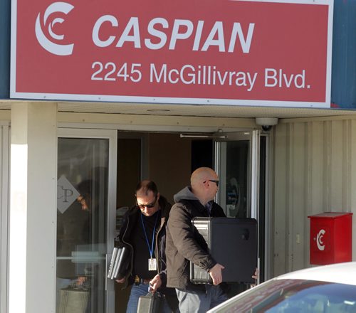 LOCAL - Caspian at 2245 McGillivray Blvd with RCMP in front. Here they remove computer equipment from the building. BORIS MINKEVICH / WINNIPEG FREE PRESS  December 17, 2014