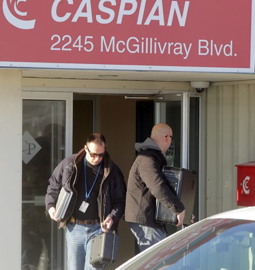 LOCAL - Caspian at 2245 McGillivray Blvd with RCMP in front. Here they remove computer equipment from the building. BORIS MINKEVICH / WINNIPEG FREE PRESS  December 17, 2014