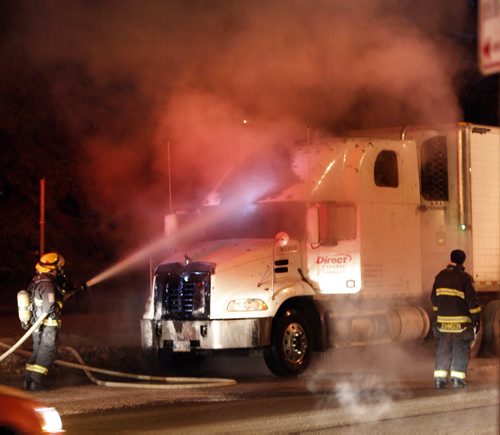 Winnipeg Fire Fighters extinguish a semi tractor on fire on Ness Ave. in the west bound lane near Conway St. Thursday morning. No reports of injuries. Wayne Glowacki / Winnipeg Free Press Dec.18 2014