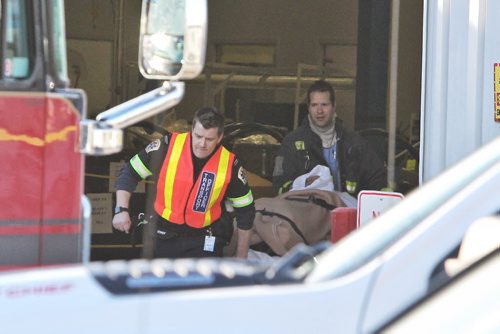 One of two employees at Standard Aero on Sargent Avenue is brought out to an ambulance after an explosion occurred at the industrial facility Thursday morning. Both were transported to hospital.  141218 December 18, 2014 Mike Deal / Winnipeg Free Press