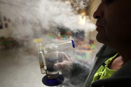 Medicinal user Richard Barahona smokes concentrate marijuana in a bong in the Vapes on Main- 93.5 Albert Street -See Stephen Burns story. Dec 18, 2014   (JOE BRYKSA / WINNIPEG FREE PRESS)