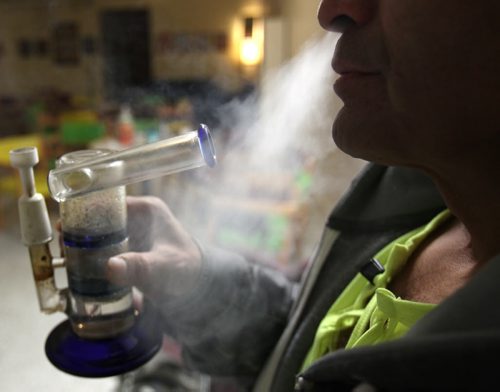 Medicinal user Richard Barahona smokes concentrate marijuana in a bong in the Vapes on Main- 93.5 Albert Street -See Stephen Burns story. Dec 18, 2014   (JOE BRYKSA / WINNIPEG FREE PRESS)