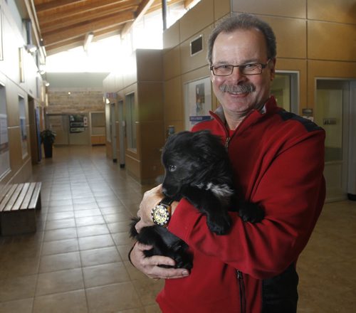 Winnipeg Humane Society CEO Bill McDonald is leaving in January to take a position with a US-based foundation that funds animal shelters, spay and neuter clinics, etc. across North America. He is holding a puppy named Holly at the Winnipeg Humane Society. Wayne Glowacki / Winnipeg Free Press Dec.18 2014