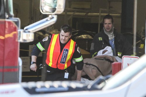 One of two employees injured in a small explosion at Standard Aero on Sargent Avenue is brought out to an ambulance this morning. Both were transported to hospital.  141218 - Thursday, December 18, 2014 -  (MIKE DEAL / WINNIPEG FREE PRESS)