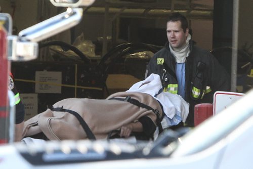 One of two employees injured in a small explosion at Standard Aero on Sargent Avenue is brought out to an ambulance this morning. Both were transported to hospital.  141218 - Thursday, December 18, 2014 -  (MIKE DEAL / WINNIPEG FREE PRESS)