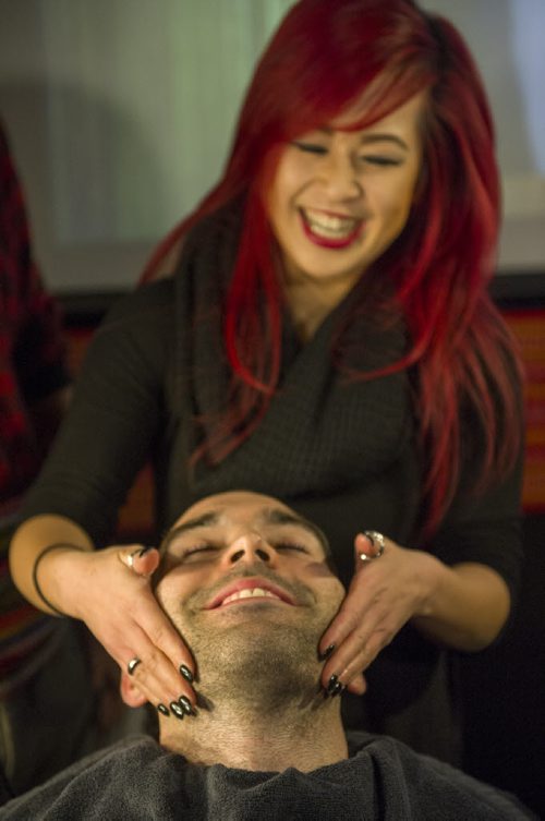 121218 Winnipeg - DAVID LIPNOWSKI / WINNIPEG FREE PRESS  Colin Ward has his beard shaved off by Holly Hui of Berns & Black Salons and Spa at the Festival du Voyageur kick off party for the 33rd annual Beard Growing Contest Thursday December 18, 2014 at Garage Caf¾©.