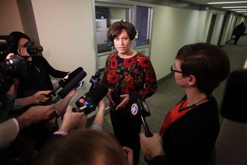 Theresa Oswald takes questions from the media in a scrum outside the NDP office Friday after officially signing the paperwork to enter the Manitoba NDP's leadership race.  Dec 19/14 Ruth Bonneville / Winnipeg Free Press