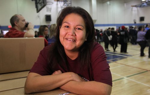 Jennifer Sinclair volunteers her time boxing up hundreds of Christmas Hampers with many volunteers at R.B. Russell School at Ma Mawi Wi Chi Itata Centre's 12th Annual Christmas Hamper Drive Saturday.   She later received a hamper from the organization for her family.  See story.  Dec 20,  2014 Ruth Bonneville / Winnipeg Free Press