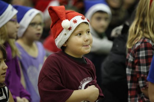 Six-year-old Timothy  Clark smiles with his elf hat on while getting his picture taken as one of the many volunteers helping out at Ma Mawi Wi Chi Itata Centre's 12th Annual Christmas Hamper Drive which took place at R.B. Russell School Saturday morning.     See story.  Dec 20,  2014 Ruth Bonneville / Winnipeg Free Press