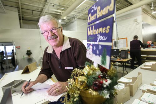 Longtime Christmas Cheer Board coordinator, Don Brown works at the main counter on one of the busiest days of the year for the charity, the last Saturday before Christmas. Feature story on the Christmas Cheer Board.  Dec 20, 2014 Ruth Bonneville / Winnipeg Free Press