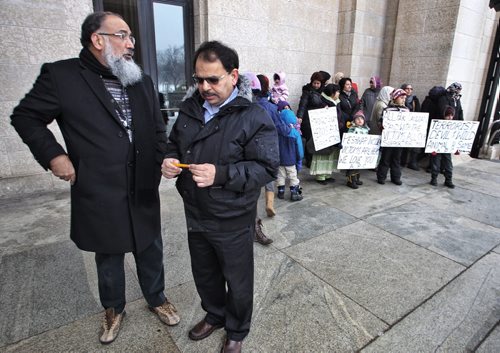 Dr Naseer Warraich (left) and Nadeem Ahmed from the Association of Pakistan Canadians along with members of the Pakistan muslim community gathered at the Manitoba Legislative Building to condemn the attack on the school in Pakistan.  141221 December 21, 2014 Mike Deal / Winnipeg Free Press