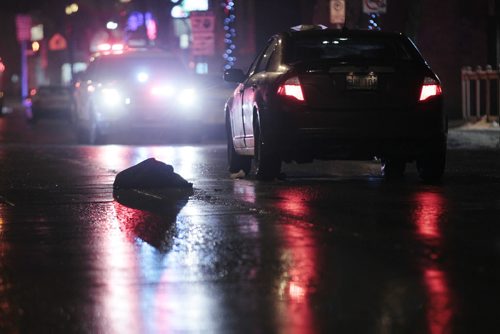 December 21, 2014 - 141221  -  A pedestrian's coat lies on the street as police investigate a pedestrian mvc on Corydon at Wentworth Sunday, December 21, 2014. John Woods / Winnipeg Free Press