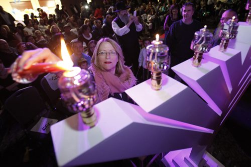 December 21, 2014 - 141221  -  Ahava Halpren lights a menorah candle during a Chanukah celebration at the Chabab-Lubavitch Jewish Learning Centre Sunday, December 21, 2014. John Woods / Winnipeg Free Press