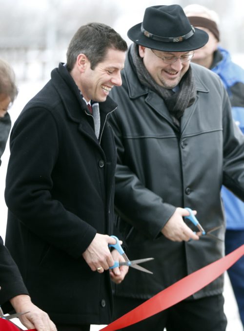 LOCAL .  file  for art with scissors  cutting  theme .  left Mayor Brian Bowman and Councillor Russ Wyatt  cut ribbon officially Open New Transcona Boulevard at 10:00 AM Monday .City of Winnipeg Funded Road to Improve East-West Connections in Transcona Winnipeg, MB Äì December 19, 2014 Äì Transcona drivers will have an easier time traveling east and west within the community when the new Transcona Boulevard officially opens on Monday. The new street, which was fully funded by the City of Winnipeg, extends from Kildare Avenue (at Plessis Road) through the old City of Winnipeg Public Works yard and connects with Ravelston Avenue W.The construction of Transcona Blvd. is part of the Transcona West Road Enhancement Project. Nearly 400 acres in Transcona have been earmarked for residential development. The multi-phase developments will include single-family and multi-family housing . Dec. 22 2014 / KEN GIGLIOTTI / WINNIPEG FREE PRESS