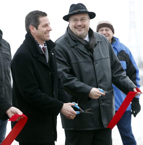 LOCAL .left  Mayor Brian Bowman and Councillor Russ Wyatt  cut ribbon  officially Open New Transcona Boulevard at 10:00 AM Monday .City of Winnipeg Funded Road to Improve East-West Connections in Transcona Winnipeg, MB Äì December 19, 2014 Äì Transcona drivers will have an easier time traveling east and west within the community when the new Transcona Boulevard officially opens on Monday. The new street, which was fully funded by the City of Winnipeg, extends from Kildare Avenue (at Plessis Road) through the old City of Winnipeg Public Works yard and connects with Ravelston Avenue W.The construction of Transcona Blvd. is part of the Transcona West Road Enhancement Project. Nearly 400 acres in Transcona have been earmarked for residential development. The multi-phase developments will include single-family and multi-family housing . Dec. 22 2014 / KEN GIGLIOTTI / WINNIPEG FREE PRESS