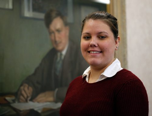 LOCAL . RRC Journalism student Brittany Hobson John W. Dafoe Scholarship winner .JW Dafoe portrait in background  Dec. 22 2014 / KEN GIGLIOTTI / WINNIPEG FREE PRESS