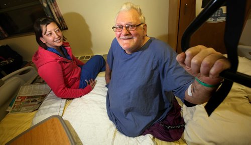 Legless and recovering from a heart attack and pneumonia in Selkirk hospital a feisty Ken Small poses (with his daughter Vanessa Dubowits), in his hospital bed Monday. See Alex Paul's story re:the intruder / thief that robbed him in his own home. December 22, 2014 - (Phil Hossack / Winnipeg Free Press)