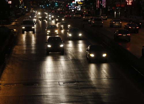 Stdup . Portage Ave  is wet . Road conditions are wet but good inside the city , highways west of of Winnipeg are slippery with temps expected to be around zero for a high .Dec. 23 2014 / KEN GIGLIOTTI / WINNIPEG FREE PRESS