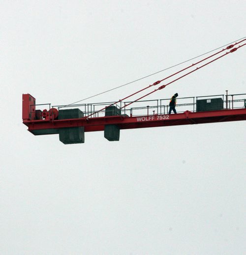 Watch that Ice- A crane operator heads back to control tower on top of crane at the Heritage Landing apartment building under construction on Assiniboine Avenue in Winnipeg- Standup Photo  Dec 23, 2014   (JOE BRYKSA / WINNIPEG FREE PRESS)