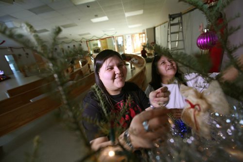 Francine Guimond and her mom Elizabeth Morriseau share some laughs as they decorate the tree together in santuary of St. Alexander Parish church in Sagkeeng First Nation.  See Randy Turner and Gord Sinclair story. Dec 19,  2014 Ruth Bonneville / Winnipeg Free Press