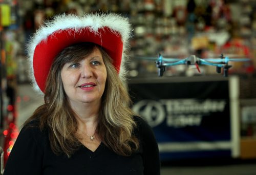 Eliminator RC co-owner  Laurrie Gobeil keeps a close eye on a drone hovering in her Higgins ave toy store Tuesday.  Drones are, ahem, flying off the shelves and under Christmas trees....See Jesse Winter story...... December 23, 2014 - (Phil Hossack / Winnipeg Free Press)