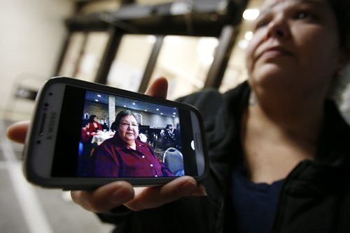 December 23, 2014 - 141223  -  Stephanie Bradley, whose mother Marlene Pelletier was killed and her children injured in a car collision, returned home to find that someone had broken in and stolen christmas gifts and money. Bradley shows a photo of her mother as she talks to media outside HSC Tuesday, December 23, 2014.  John Woods / Winnipeg Free Press