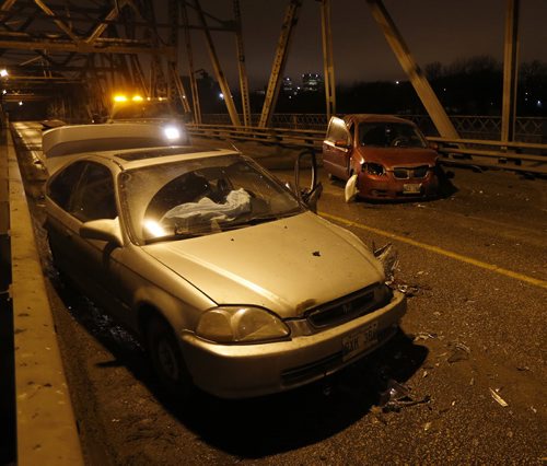 LOCAL .Two vehicle MVC closed the Louise Bridge around 6:30am Wed. Morning , two heavily front end damaged cars blocked the bridge . Police say there were no serious injuries , airbags were deployed. . Tow trucks are clearing the damage  Dec. 24 2014 / KEN GIGLIOTTI / WINNIPEG FREE PRESS