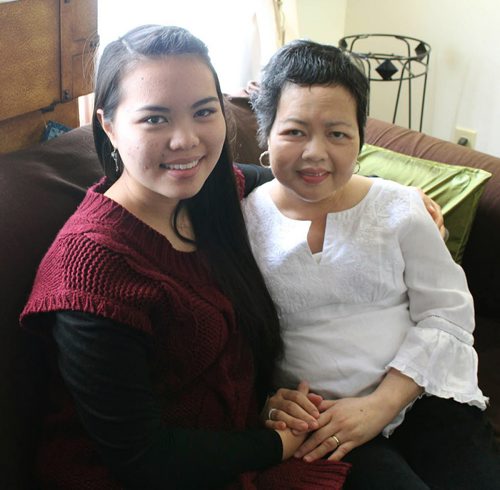 Winnipeg, MB - Jamie Pempengco (L) sits with her mother Amalia Pempengco, who has been diagnosed with with metastatic cancer, in the living room of their home. AmaliaÄôs extensive volunteer efforts with Canadian Blood Services has inspired Jamie to follow in her momÄôs footsteps. December 25, 2014.  ERIN DEBOOY STORY/PHOTO