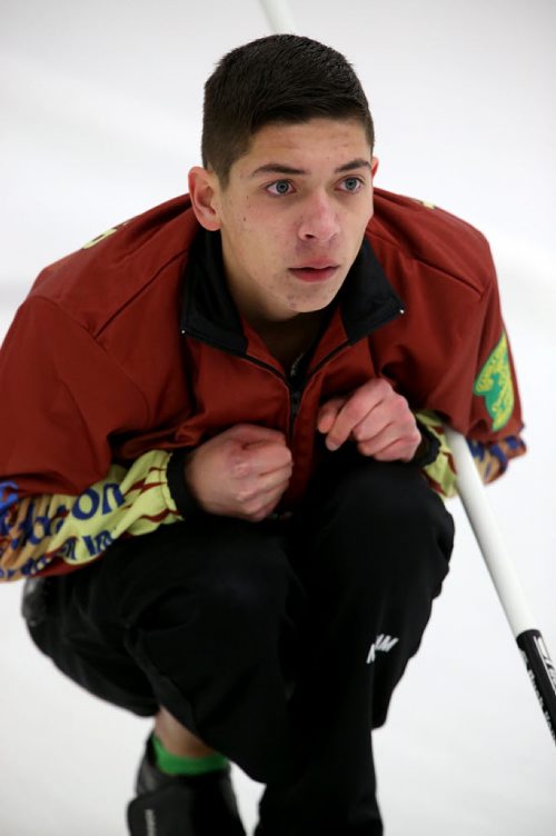 Hayden Forrester watches his shot during the 2015 Junior Provincial Curling Championships at the Assiniboine Memorial Curling Club, Friday, December 26, 2014. (TREVOR HAGAN/WINNIPEG FREE PRESS)