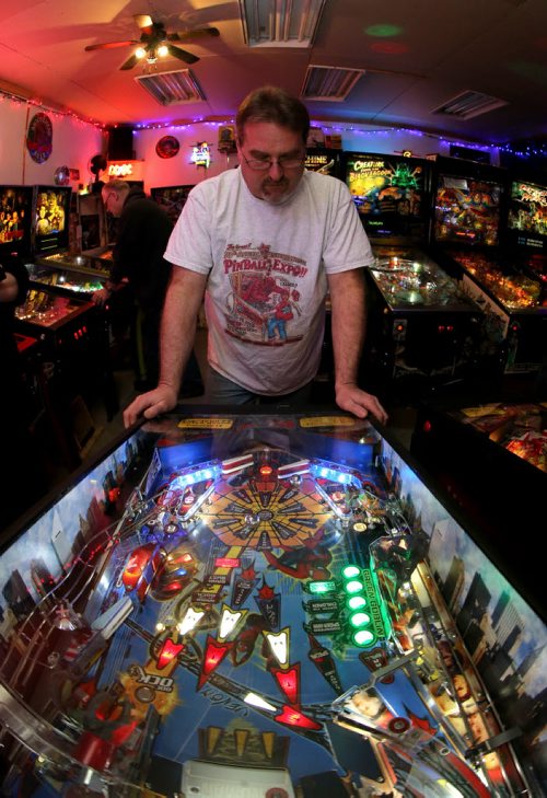 Rick owns close to 50 pinball machines and hosts a group every Friday to play pinball, Friday, December 26, 2014. (TREVOR HAGAN/WINNIPEG FREE PRESS) - for dave sanderson