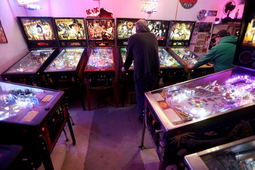 Enthusiasts playing. Rick owns close to 50 pinball machines and hosts a group every Friday to play pinball, Friday, December 26, 2014. (TREVOR HAGAN/WINNIPEG FREE PRESS) - for dave sanderson