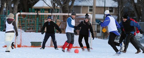 Marnie Feeleus and Mark Reed fight for the ball during soccer action at the 16th annual ÄòSnow BowlÄô at La Verendrye School in Crescentwood on Dec. 27, 2014. Photo by Jason Halstead/Winnipeg Free Press