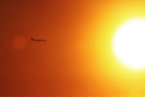 A plane is silhouetted by the sun as it approaches the Winnipeg James Armstrong airport late Sunday afternoon.  141228 December 28, 2014 Mike Deal / Winnipeg Free Press