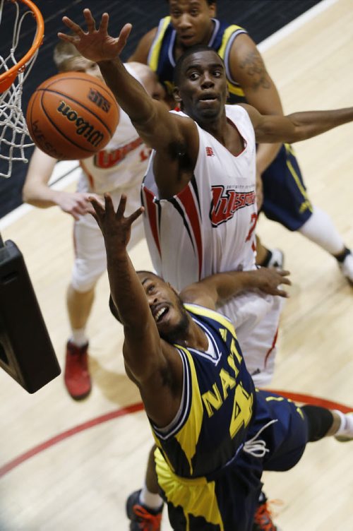 December 28, 2014 - 141228  - NAIT's Alvin Parker (4) goes up for two against University of Winnipeg's Jelane Pryce (7) in the university semi-final game in the Wesmen Classic at the University of Winnipeg Sunday, December 28, 2014.  John Woods / Winnipeg Free Press