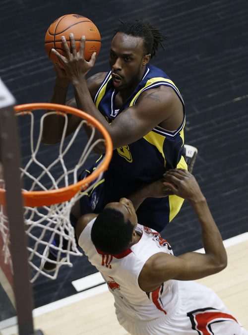 December 28, 2014 - 141228  - NAIT's Donny Moss (8) drives over University of Winnipeg's Mark McNee (2) on the way to 2 points in the university semi-final game in the Wesmen Classic at the University of Winnipeg Sunday, December 28, 2014.  John Woods / Winnipeg Free Press