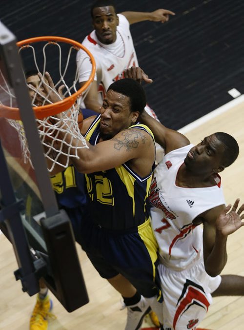 December 28, 2014 - 141228  - NAIT's Troy Barnes (22) and University of Winnipeg's Jelane Pryce (7) go up for the rebound in the university semi-final game in the Wesmen Classic at the University of Winnipeg Sunday, December 28, 2014.  John Woods / Winnipeg Free Press