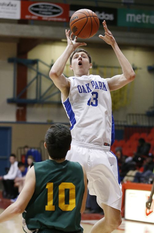 December 28, 2014 - 141228  - Oak Park Raiders William Kohler (13) goes up for the 2 points against John Taylor Pipers Risto Zimbakov (10) in the high school semi-final game in the Wesmen Classic at the University of Winnipeg Sunday, December 28, 2014.  John Woods / Winnipeg Free Press