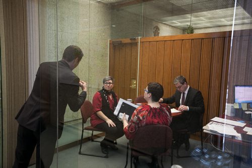 11:15:28 AM Before leaving for this first public appearance of the day after lunch, Bowman pops in on a staff meeting in chief of staff Jason Fuith's glass-walled office.  141215 - Monday, December 15, 2014 - (Melissa Tait / Winnipeg Free Press)