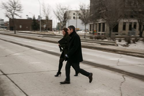 12:25:19 PM Bowman and Johanna Wood hustle across Main Street on their way to Siloam Mission after leaving the Sport of Life Centre. Bomwan says he's annoyed by walking slowly, and is always leading the staff at a brisk pace. 141215 - Monday, December 15, 2014 - (Melissa Tait / Winnipeg Free Press)